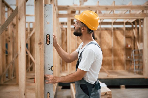 Leveling device. Industrial worker in wooden warehouse.